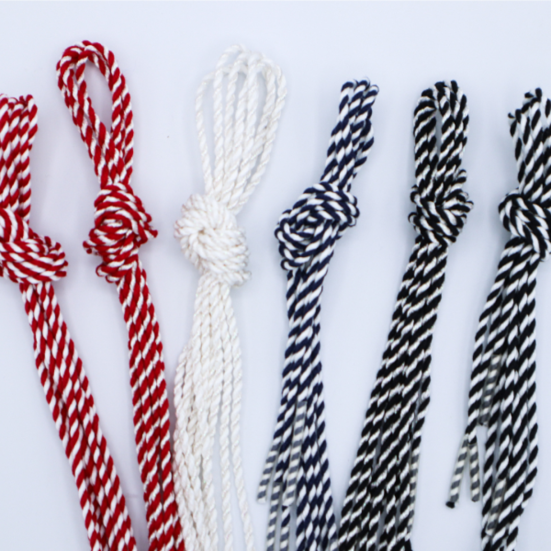 Needlepoint finishing cording in red, cream, navy, and black
